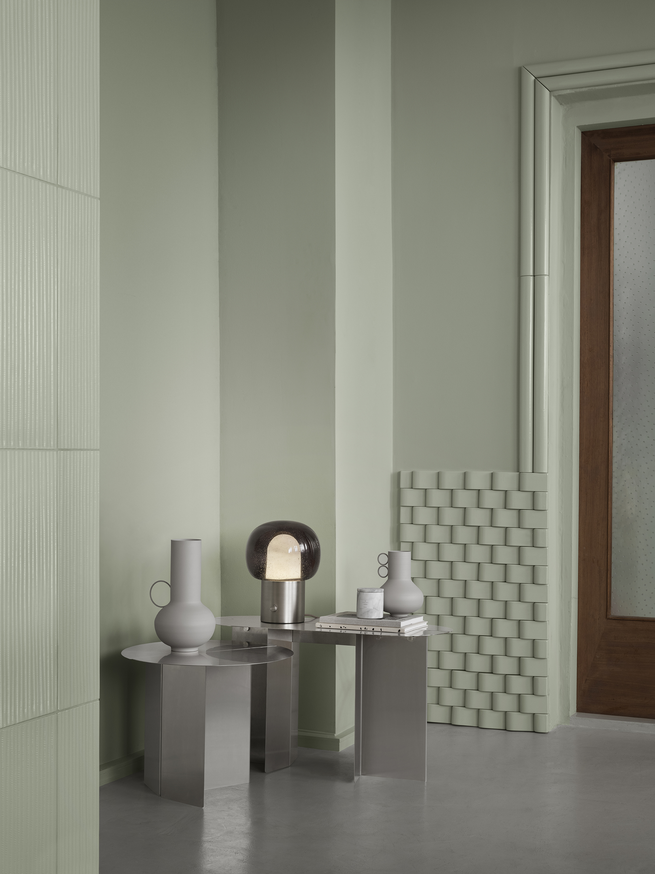 stainless steel sídeboard from blomus with a lamp on it