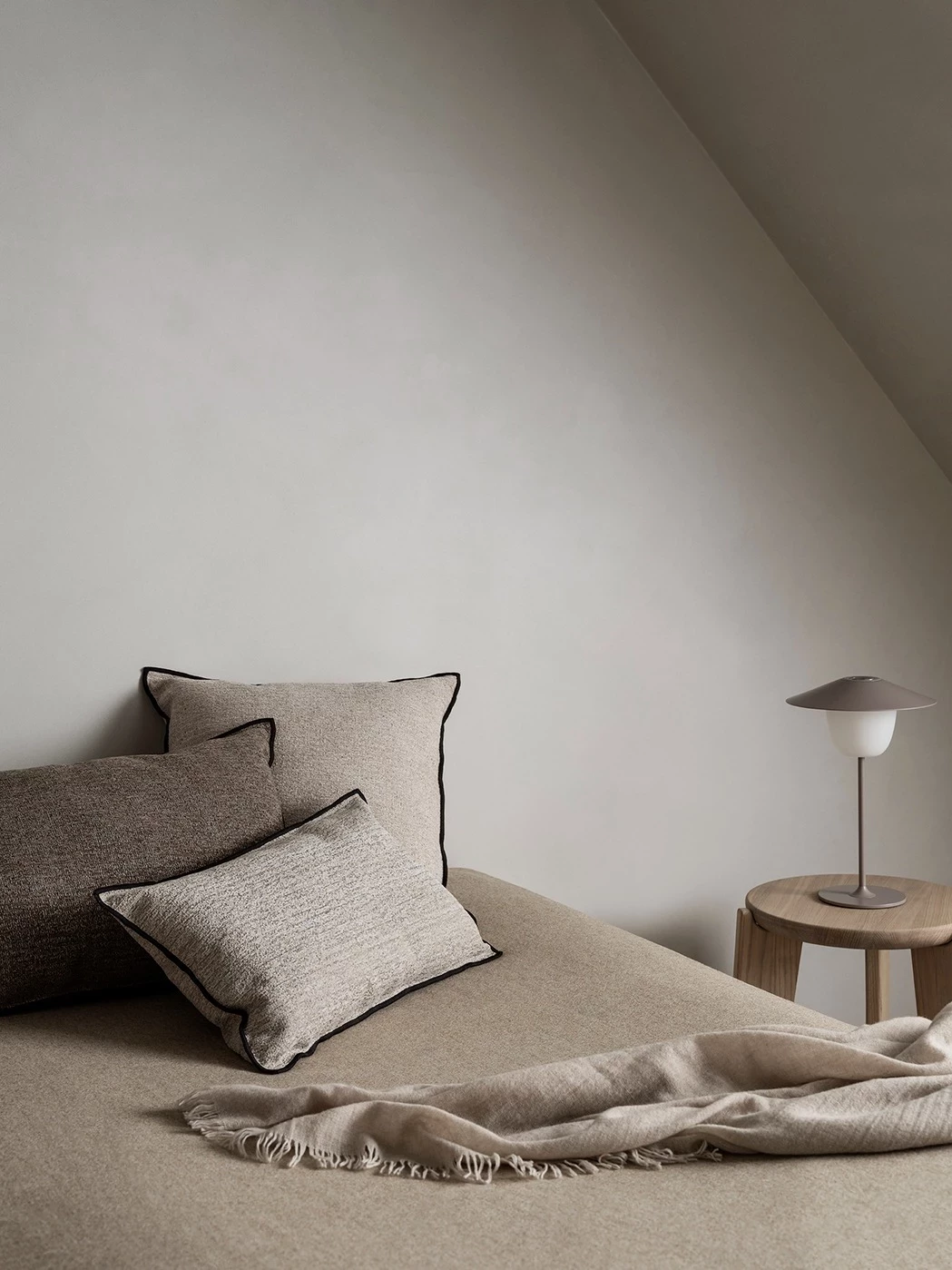 blanke on sofa with lamp and pillows
